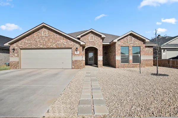 a view of a house with a yard and garage