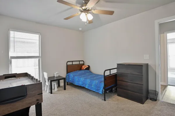 a view of a bathroom with wooden floor and windows