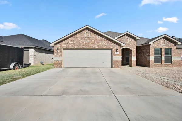 a view of a house with a yard and garage