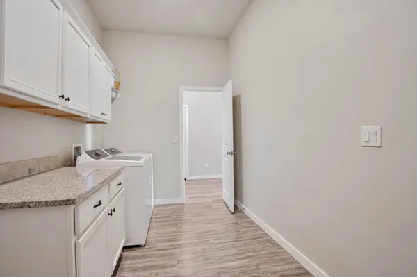 a en suite bathroom with a granite countertop tub and a sink