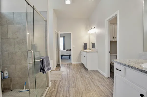 a bathroom with a granite countertop shower mirror and a sink
