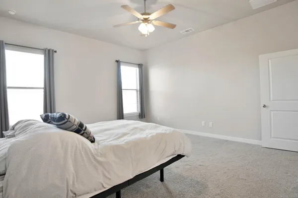 a bathroom with a granite countertop sink a toilet and shower