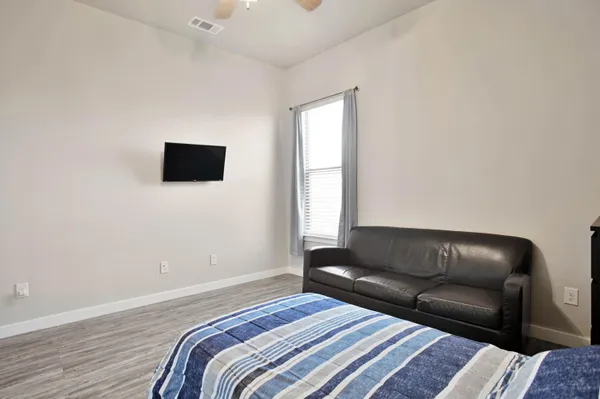 a large kitchen with stainless steel appliances a refrigerator and a stove top oven