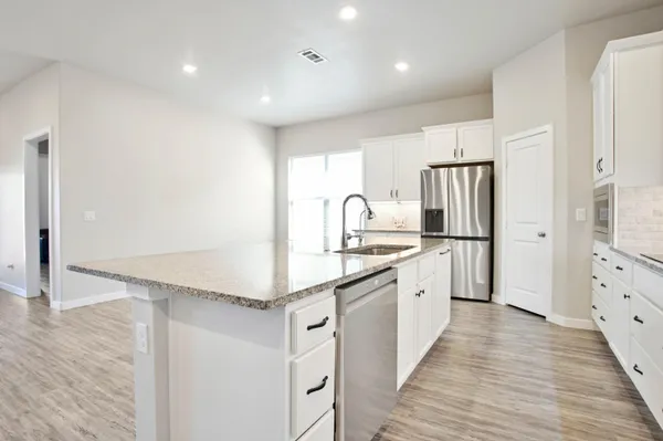 a view of kitchen with cabinets microwave and wooden floor