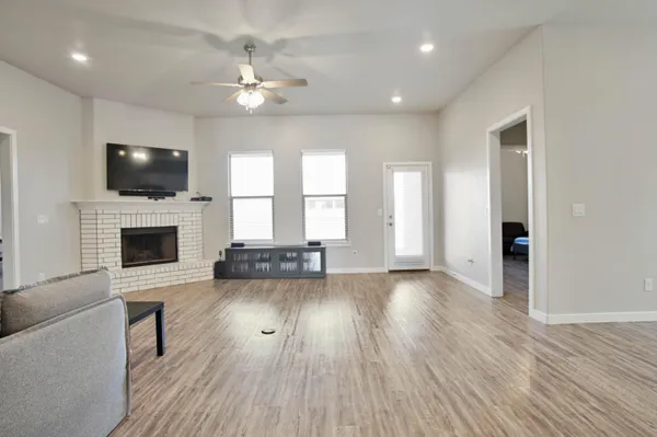 a living room with furniture and kitchen view