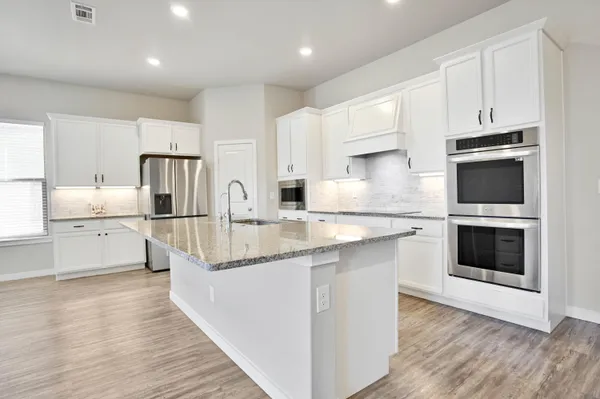 a living room with furniture and kitchen view