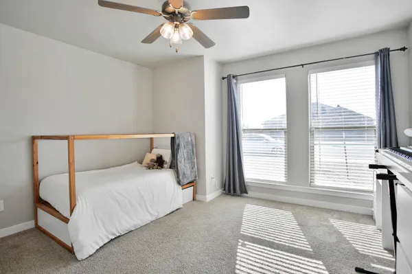 a bedroom with a large bed and a chandelier