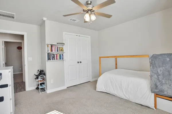 a bedroom with a bed and a chandelier