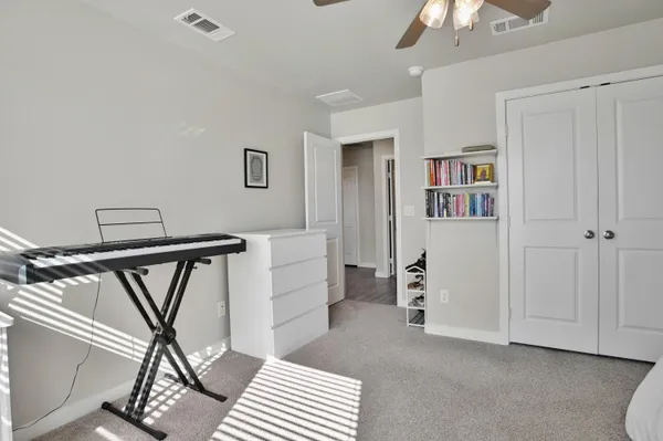 a view of a room that has a bed and a window