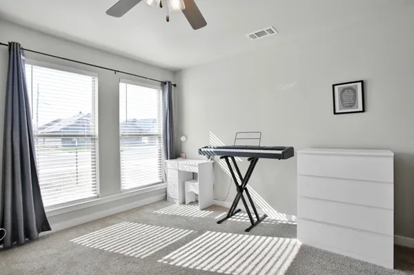a bathroom with a granite countertop sink a toilet and a mirror
