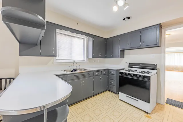 a kitchen with a stove a sink and a refrigerator