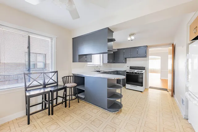 a kitchen with stainless steel appliances kitchen island granite countertop a sink and cabinets
