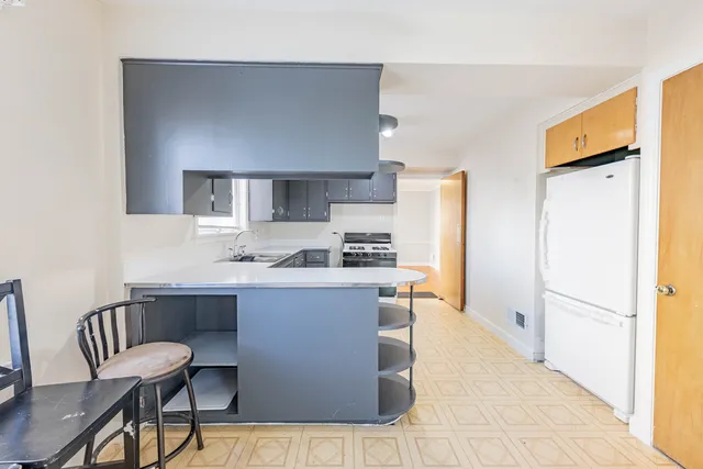 a kitchen with stainless steel appliances a sink and a refrigerator