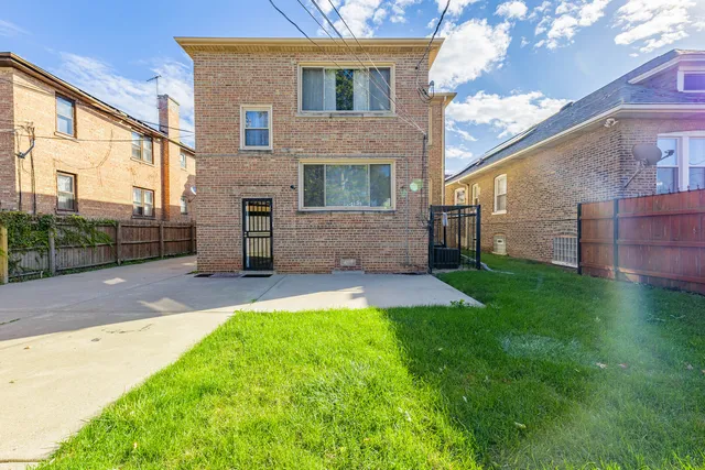 a view of a house with a yard and a garage