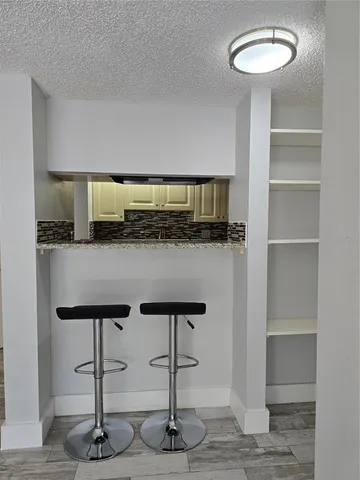 a view of a livingroom with wooden floor and staircase