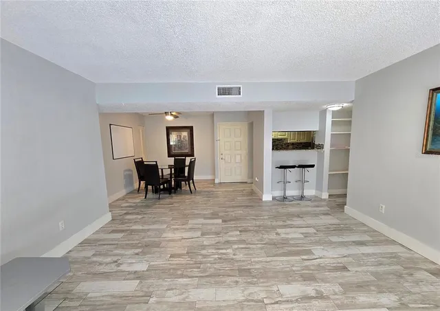 a view of a livingroom with furniture and a flat screen tv
