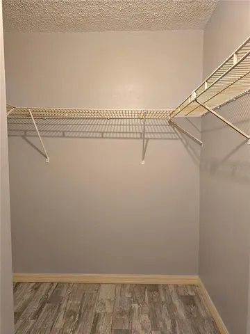 a bathroom with a granite countertop sink toilet mirror vanity and bathtub
