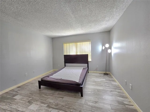 an empty room with wooden floor and closet