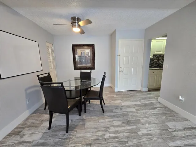 a kitchen with granite countertop a sink stove and refrigerator