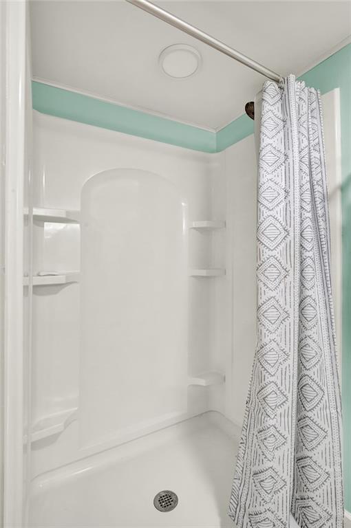 1261 Griffith Road Ligonier, PA 15658 - Photo 29 of 39 a bathroom with a shower curtain and a shower