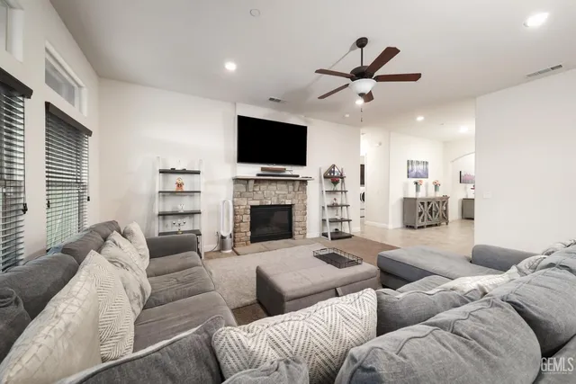 a living room with fireplace furniture and a flat screen tv