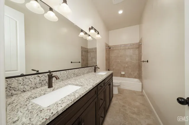 an empty room with chandelier fan and windows