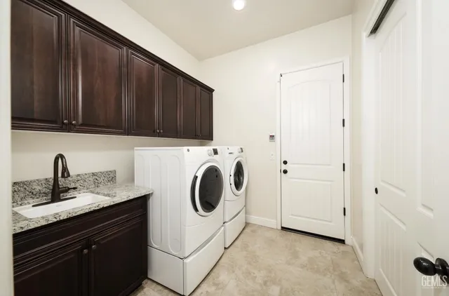 an empty room with a chandelier fan and windows