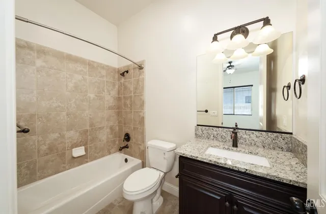 a spacious bedroom with a large bed and a chandelier