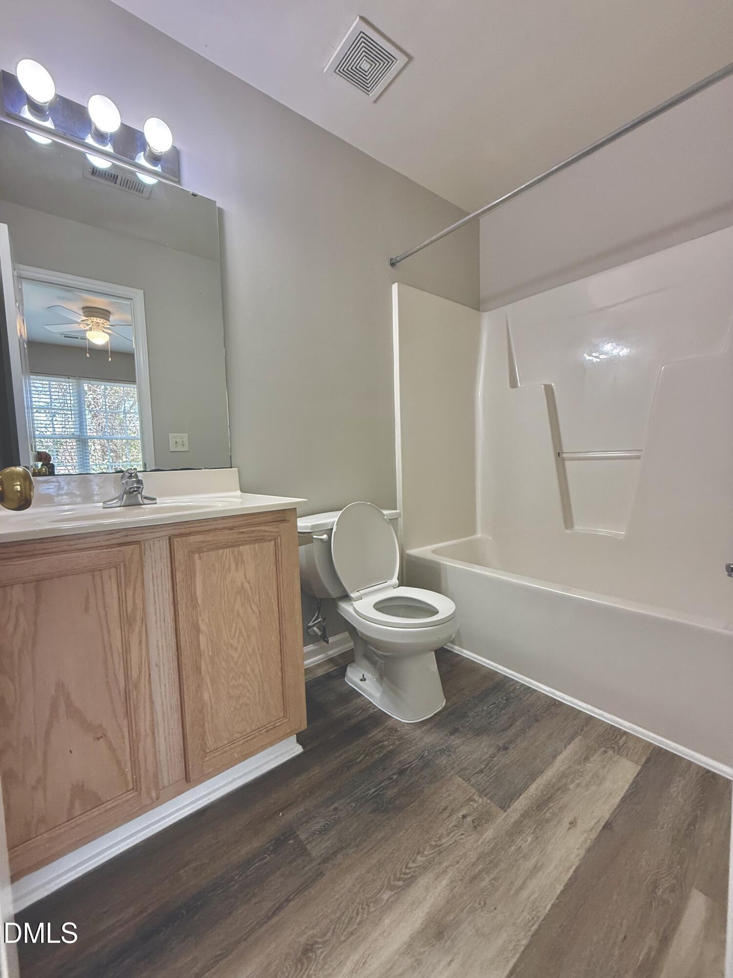 10 Red Lane Raleigh, NC 27606 - Photo 12 of 13 a bathroom with a sink a toilet a mirror and shower