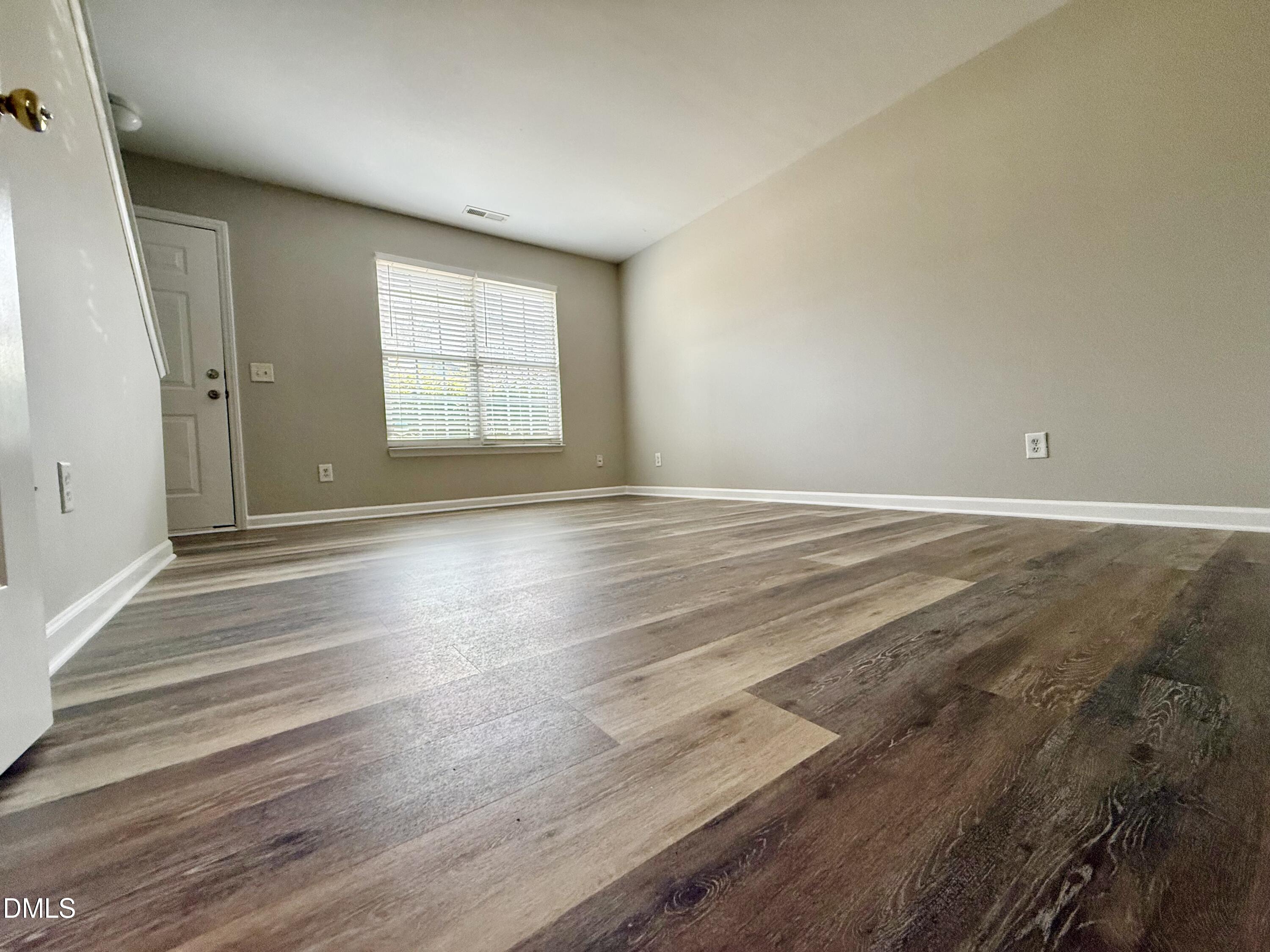 10 Red Lane Raleigh, NC 27606 - Photo 2 of 13 a view of an empty room with wooden floor and a window