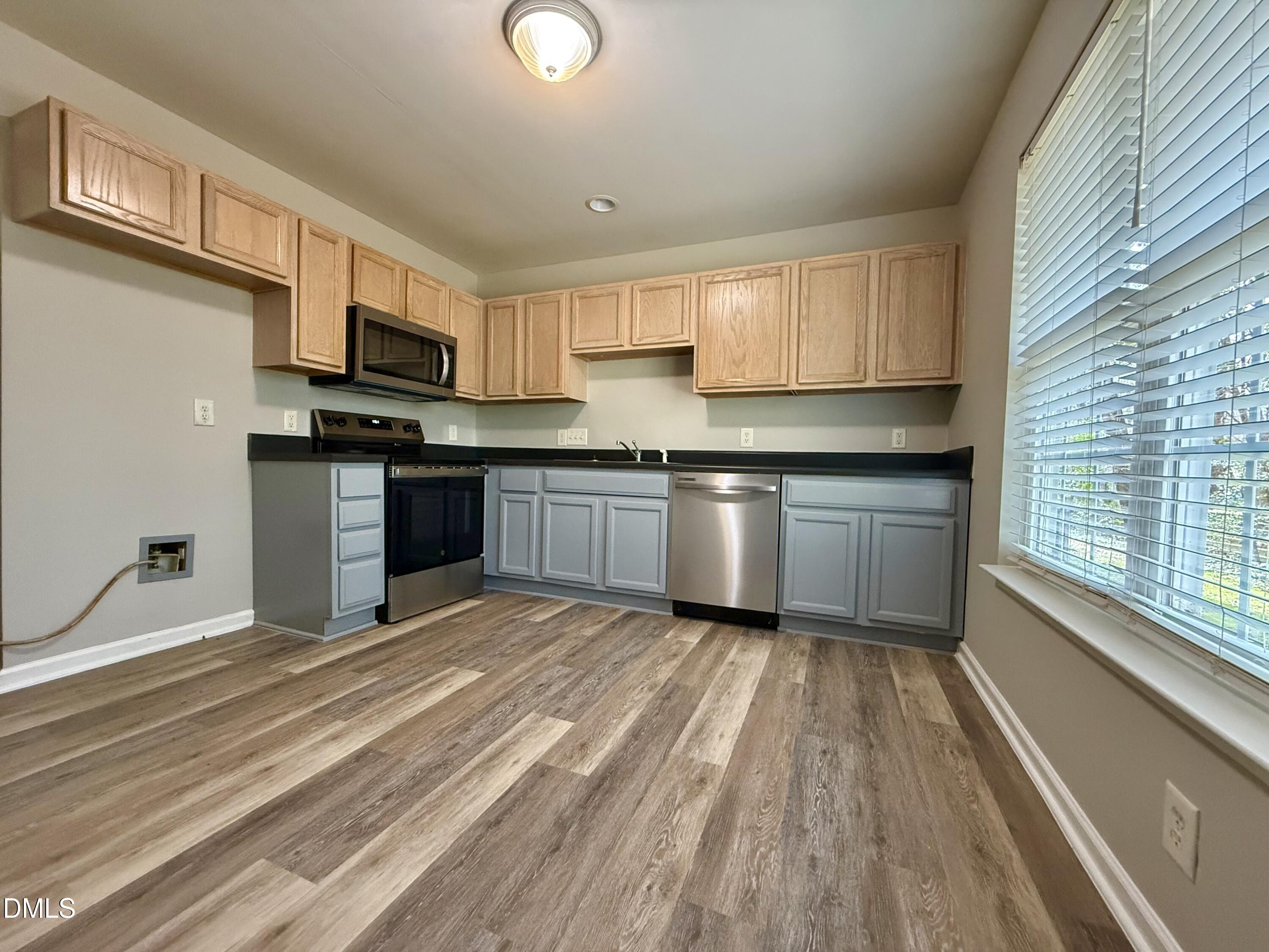 10 Red Lane Raleigh, NC 27606 - Photo 5 of 13 a kitchen with stainless steel appliances granite countertop a stove top oven a sink dishwasher a refrigerator and white cabinets with wooden floor