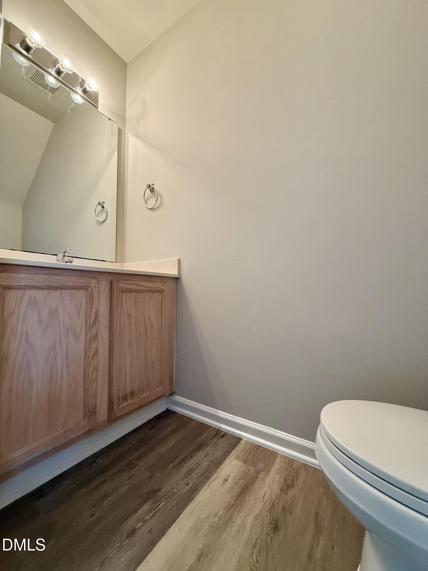 10 Red Lane Raleigh, NC 27606 - Photo 6 of 13 a bathroom with a sink a toilet and vanity