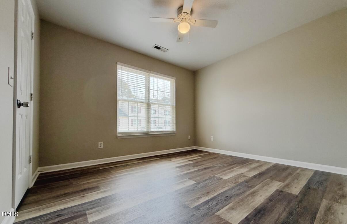 10 Red Lane Raleigh, NC 27606 - Photo 9 of 13 wooden floor in an empty room with a window