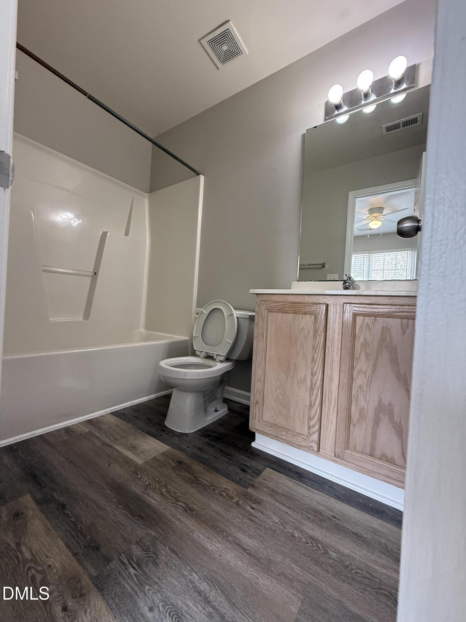 10 Red Lane Raleigh, NC 27606 - Photo 10 of 13 a bathroom with a toilet a sink and mirror