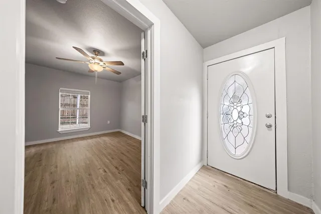 a view of an entryway with wooden floor