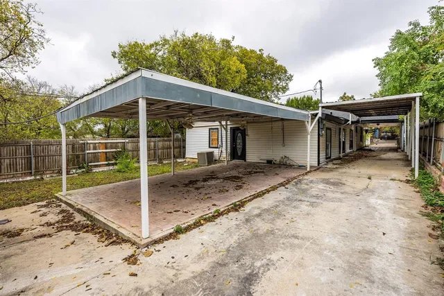 a view of a backyard with wooden fence