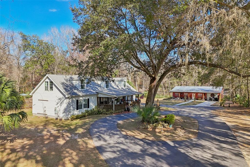 7459 Southwest 5th Avenue Ocala, FL 34476 - Photo 1 of 55 a view of a white house next to a road and yard