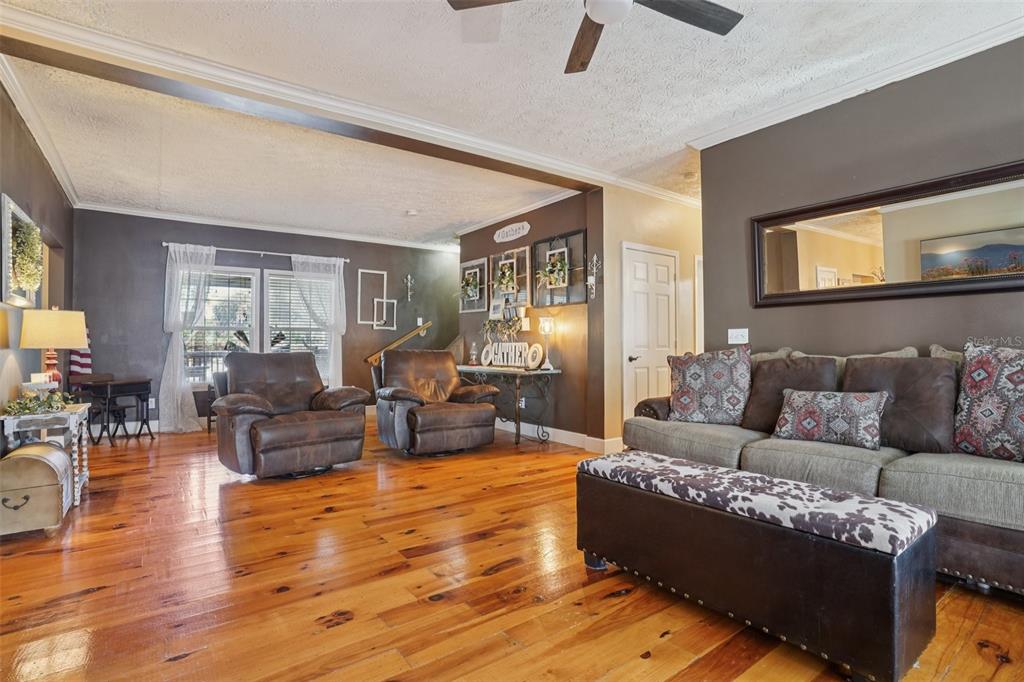 7459 Southwest 5th Avenue Ocala, FL 34476 - Photo 12 of 55 a living room with furniture and a wooden floor