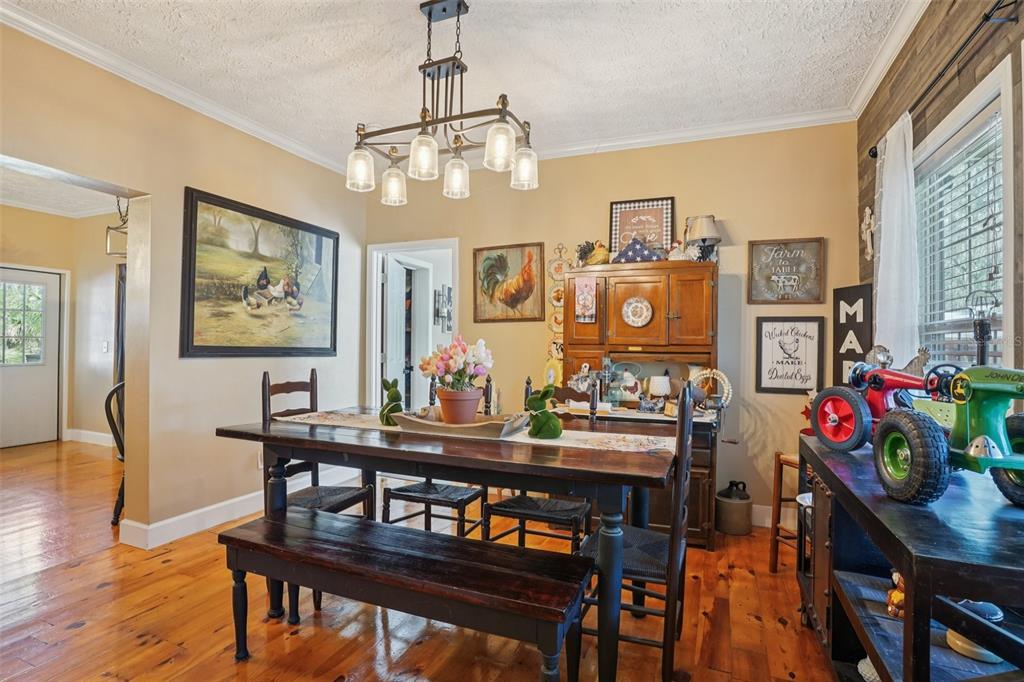 7459 Southwest 5th Avenue Ocala, FL 34476 - Photo 16 of 55 a view of a dining room with furniture and wooden floor