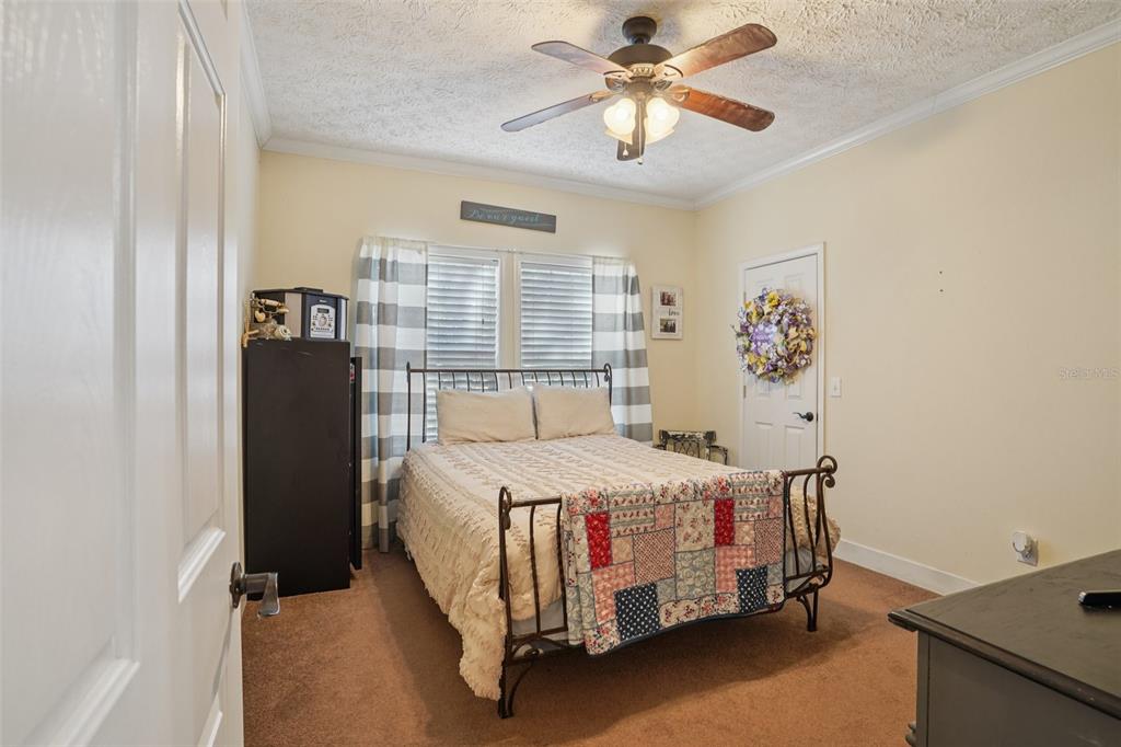 7459 Southwest 5th Avenue Ocala, FL 34476 - Photo 24 of 55 a bedroom with a bed and a chandelier