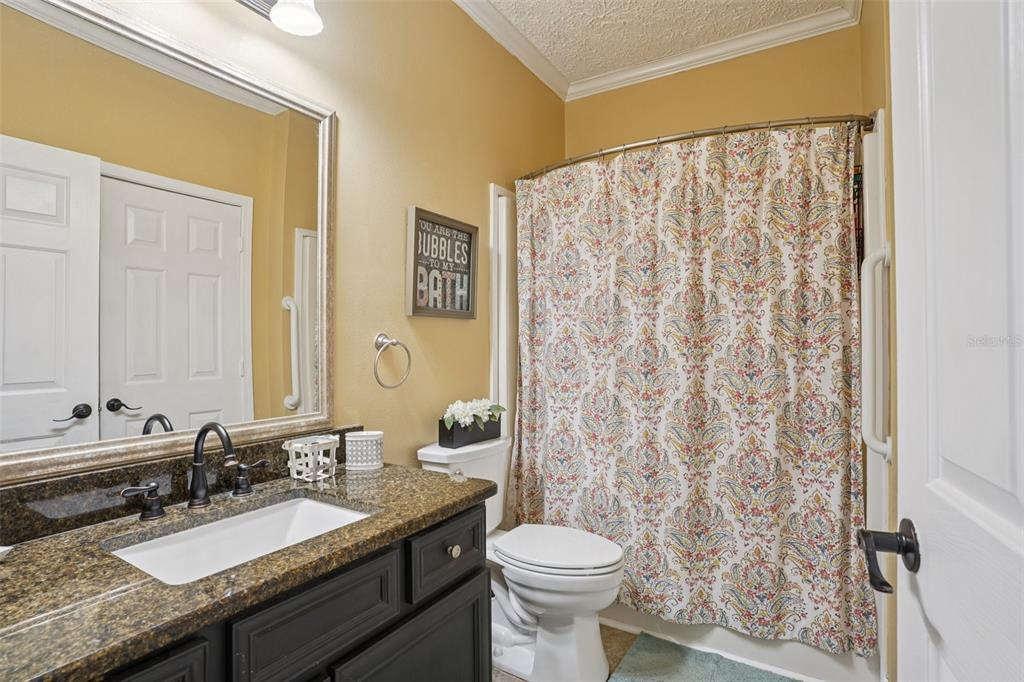 7459 Southwest 5th Avenue Ocala, FL 34476 - Photo 25 of 55 a bathroom with a granite countertop sink and a mirror