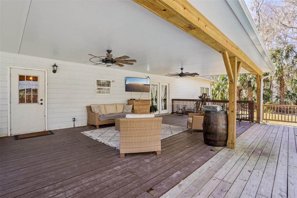 7459 Southwest 5th Avenue Ocala, FL 34476 - Photo 39 of 55 a living room with couches and kitchen view with wooden floor