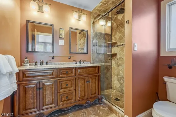 a bathroom with a granite countertop sink mirror and a shower
