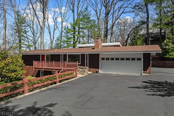 front view of a house with a large trees