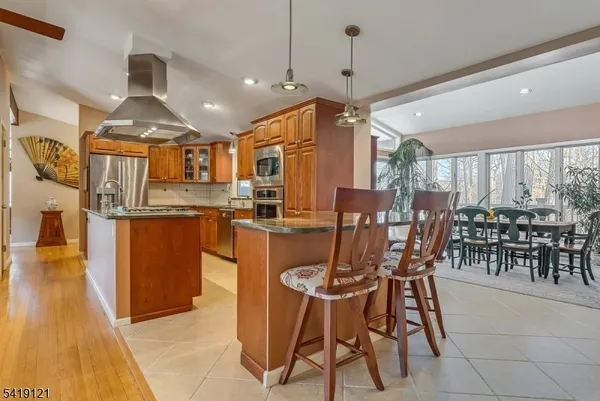a dining table chairs and a view of kitchen