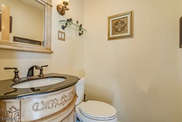 a bathroom with a sink a toilet and mirror