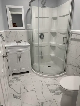 a bathroom with a sink toilet and shower