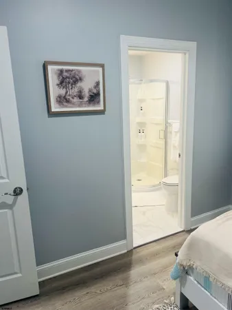 an entryway to room with wooden floor