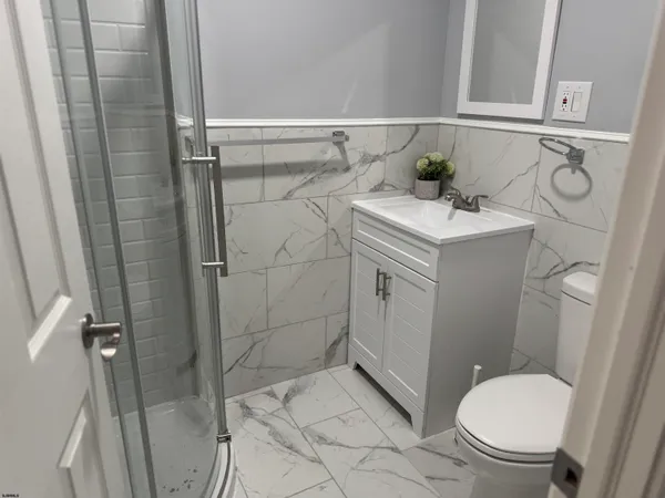 a bathroom with a sink toilet and shower