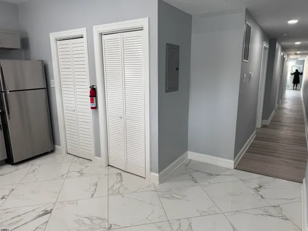 a view of a hallway with entryway doors
